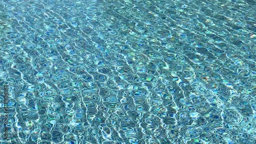 Swimming pool with blue crystal clear water surface and ripple wave background