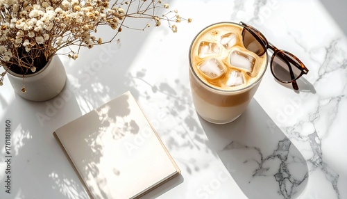 A high-angle flat lay of an iced Latte (visible beautiful layers) on a clean white