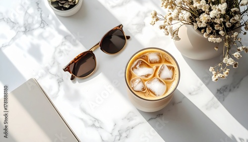 A high-angle flat lay of an iced Latte (visible beautiful layers) on a clean white