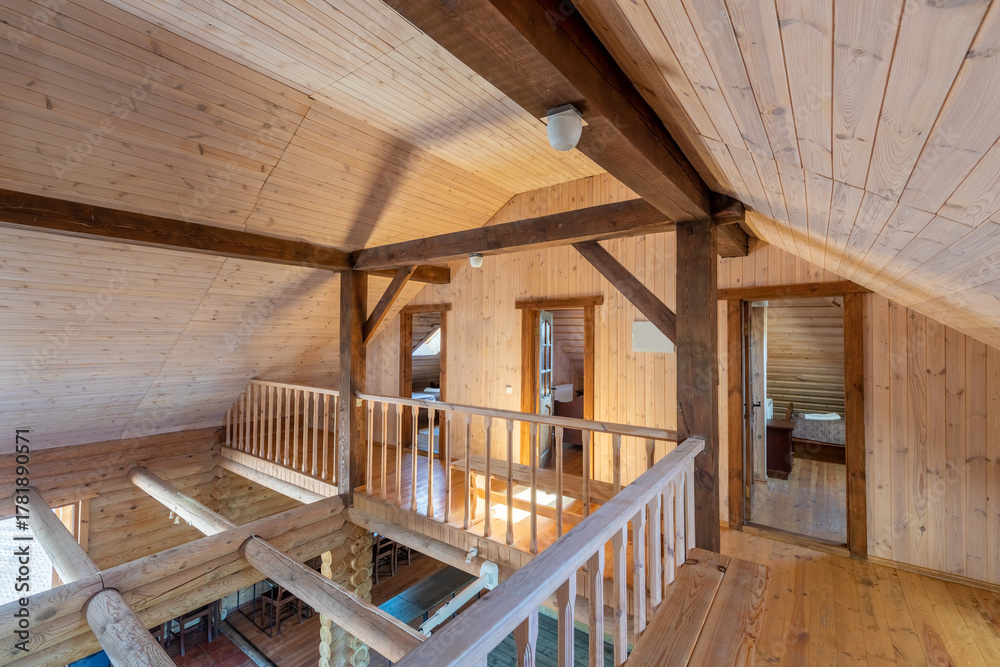 Obraz premium Rustic Wooden Attic Outfitted with Natural Light and Cozy Interior Design