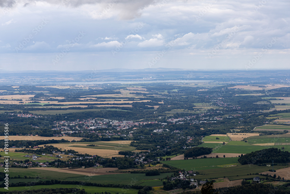 Obraz premium Opawskie Mountains, Poland. View from the summit to the mountain valley of the Czech Republic and Poland.