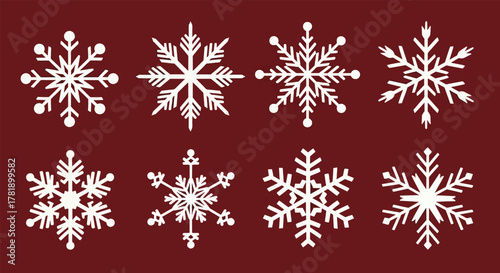 Collection of eight intricate white snowflake designs on a deep red background.