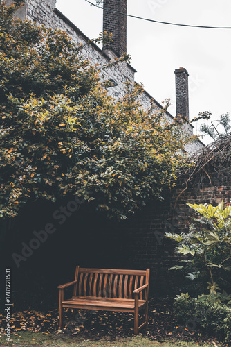 Canvas Print hidden garden with a bench in dublin ireland