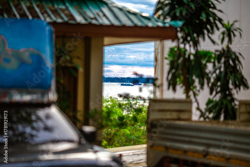 Background of a classic car steering wheel, a nine-series car with a manual transmission, a rural passenger transport vehicle in Thailand.