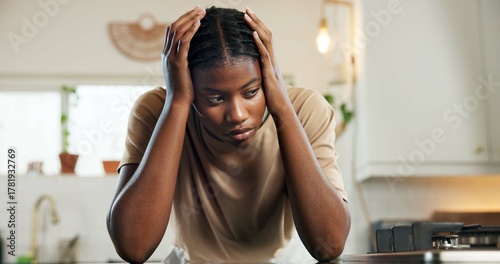 Thinking, headache and woman with stress in kitchen for burnout, overworked and household pressure. Mental health, tired and black person with depression from fatigue, overwhelmed and burden in home