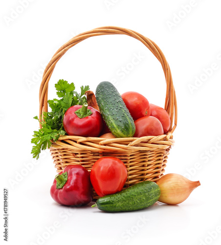 Basket with fresh vegetables isolated on white background.