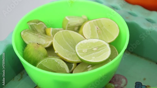 Close-up of green lime slices in a container. 4k fruits 
