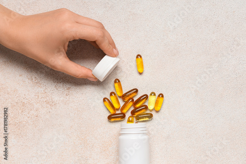 Female hand with jar of vit...