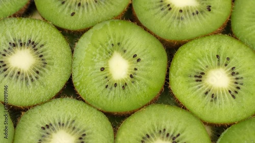 Zoom frame Sliced kiwi fruits top view, rotation. Fresh and healthy food concept