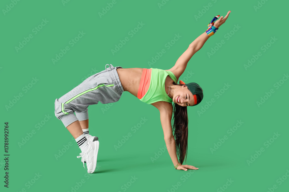 Naklejka premium Female hip-hop dancer on green background
