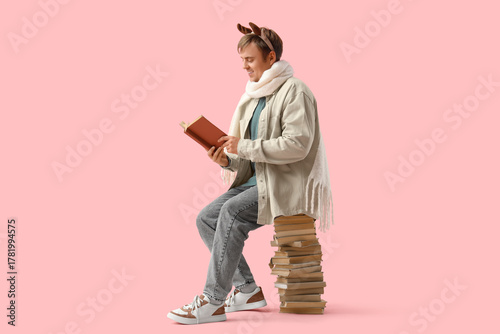 Young man with many books o...
