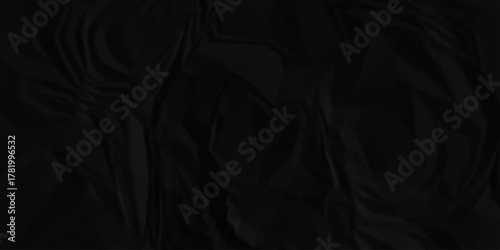 Black crumpled paper creased grunge texture. Paper wrinkled surface glued paper poster background. Crumpled and top view textures can be used for background of text or any contents.	