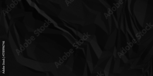 Black crumpled paper creased grunge texture. Paper wrinkled surface glued paper poster background. Crumpled and top view textures can be used for background of text or any contents.	