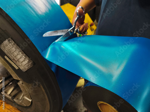  At the tire retreading factory, the master applies the bonding gum that connects the cold tread to the tire.