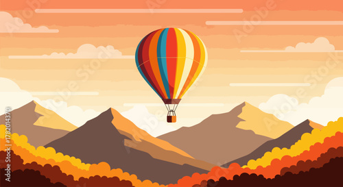 Colorful hot air balloon flying over autumn mountains at sunset  