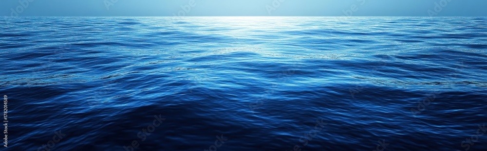 Naklejka premium Calm deep blue ocean water under bright natural sunlight with gentle ripples and reflections on the surface