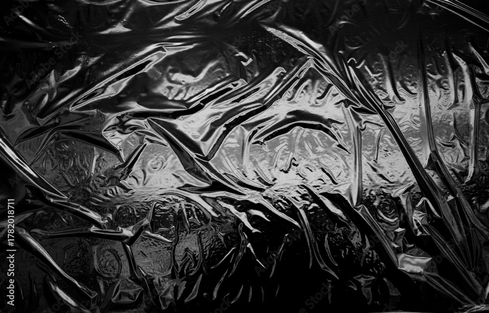 Fototapeta premium Transparent plastic wrap on a black background