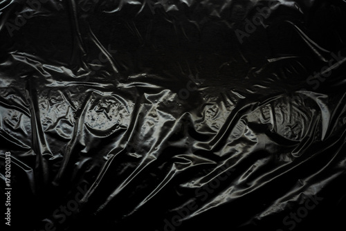Transparent plastic wrap on a black background