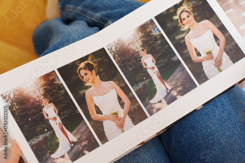 Female hands flipping through a photo book with wedding photos