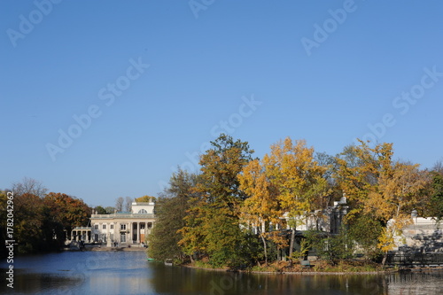 Trees with colorful leaves during foliage in autumn in an old park Lazienki in Warsaw, Poland