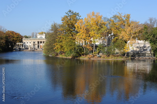 Trees with colorful leaves during foliage in autumn in an old park Lazienki in Warsaw, Poland