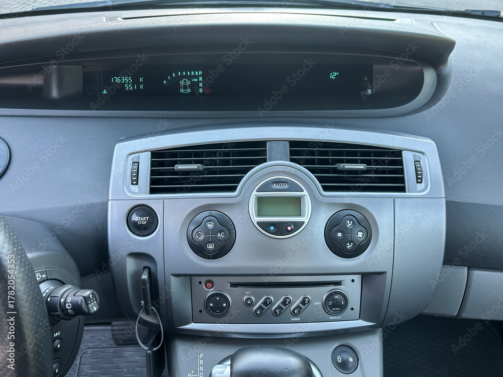 Fototapeta premium Dashboard display of a car showing the odometer reading and temperature during a sunny day drive