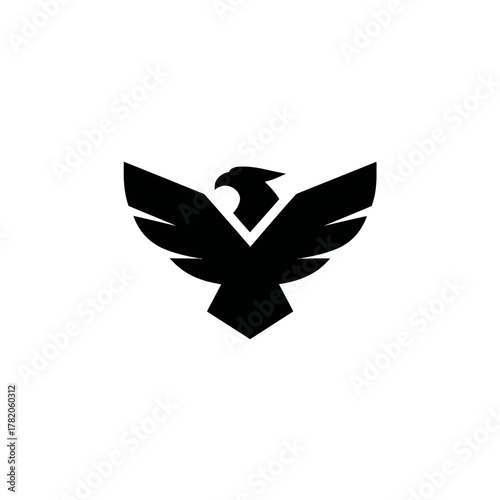 Stylized black eagle or hawk silhouette with majestic spread wings. Powerful bird of prey vector illustration, symbol of freedom.