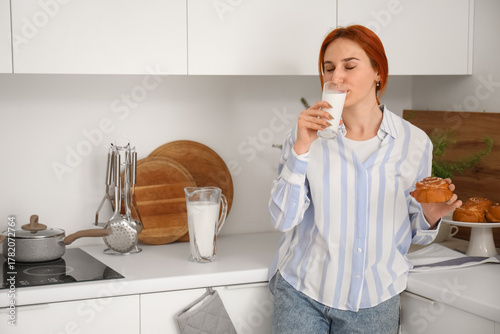 Young redhead woman with ta...