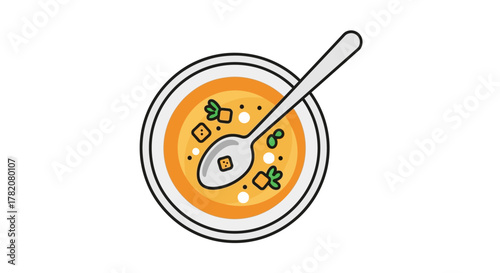 Bowl of soup with a spoon featuring croutons and vegetables