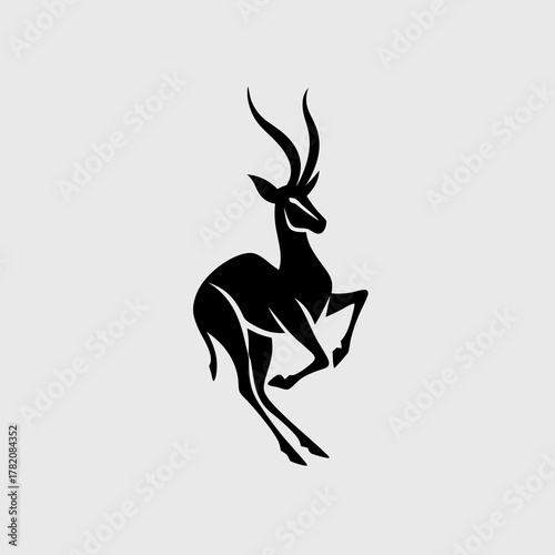 Dynamic black silhouette of a leaping antelope with elegant horns. Graceful gazelle or impala vector illustration for graphic design.