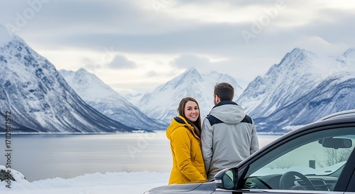 Wallpaper Mural Couple enjoying a scenic winter view of snow capped mountains and a serene lake from their car during their holiday. Torontodigital.ca
