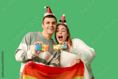 Young couple in Santa hats ...