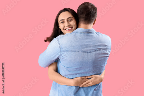 Happy young woman hugging h...
