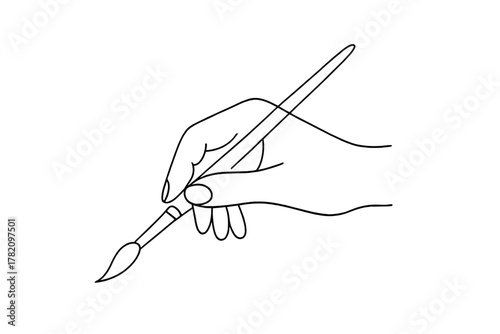 Creativity in action with a hand poised to paint using a brush on a blank canvas during an artistic moment