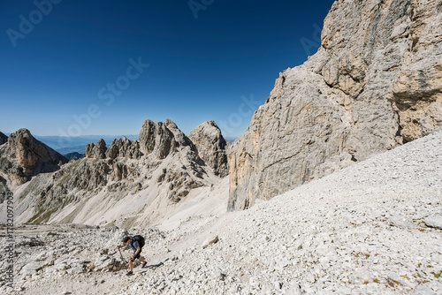 Tablou pe pânză Hiker in the South Tyrolean Dolomites, Rosengarten, Italy, exploring alpine trai