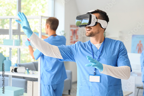 Obraz na płótnie Male doctor using VR glasses in clinic