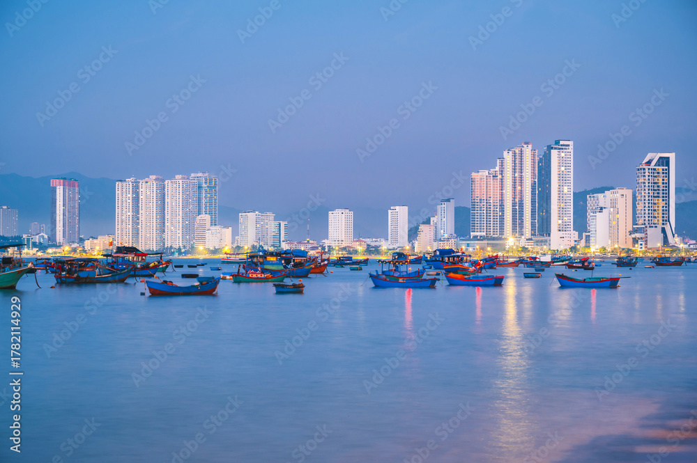 Fototapeta premium Traditional Vietnamese fishing boats at sea in Nha Trang city in Vietnam at sunrise in morning