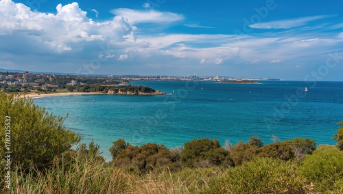 Fototapeta Naklejka Na Ścianę i Meble -  A coastal bay with lush gardens, clear water, and a sunny beach under a bright sky