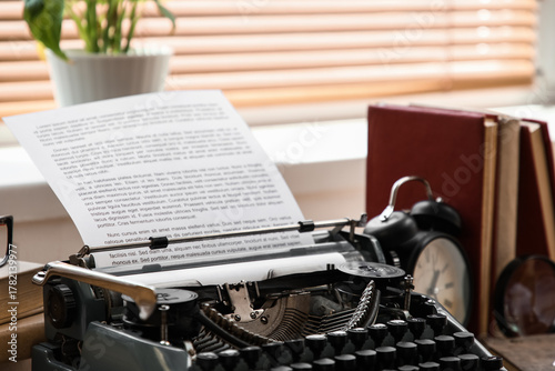 Vintage typewriter with pap...