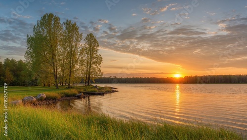Fototapeta Naklejka Na Ścianę i Meble -  Vibrant sunset reflecting on a tranquil lake surrounded by trees, evoking a sense of serenity and calmness