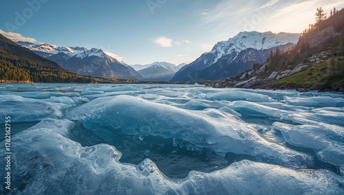 Glistening ice thawing amidst mountains and clear blue waters, seasonal change