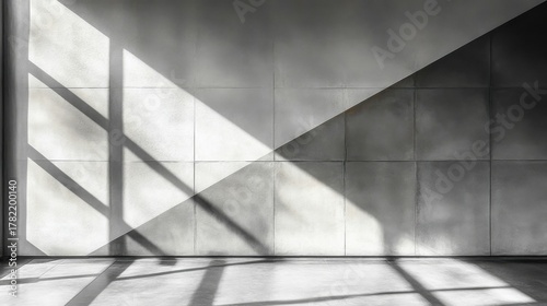 Interior view of a room with light and shadow on a concrete tiled wall