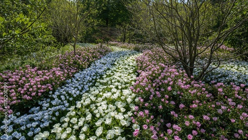 Wallpaper Mural Flowers in white, pink, and blue resembling a river, surrounded by trees, seasonal change Torontodigital.ca