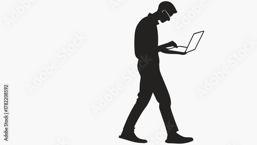 Tech Silhouette: A tech-savvy individual walks purposefully, focused on a laptop, embodying innovation and modern productivity.