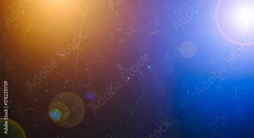 Abstract light flares and dust particles on a grunge background