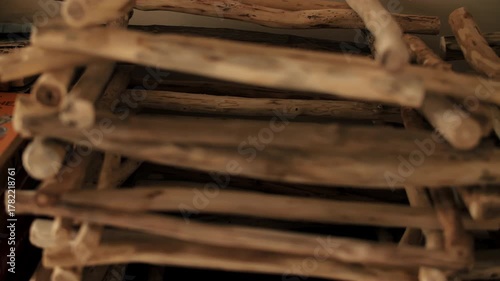 Stack of rough wooden sticks in pile