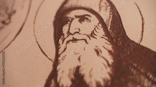 Closeup of religious engraving on leather surface