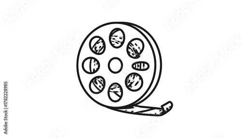 Simple black and white illustration of a film reel with perforations, holding celluloid film. An emblem of old movies