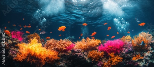 Fototapeta Naklejka Na Ścianę i Meble -  A vibrant underwater scene featuring colorful coral reefs and orange fish swimming in a clear blue ocean.