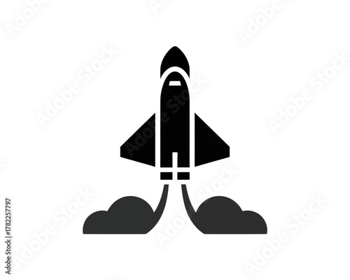 Illustration of a black rocket taking off with smoke plumes on a white background in silhouette style